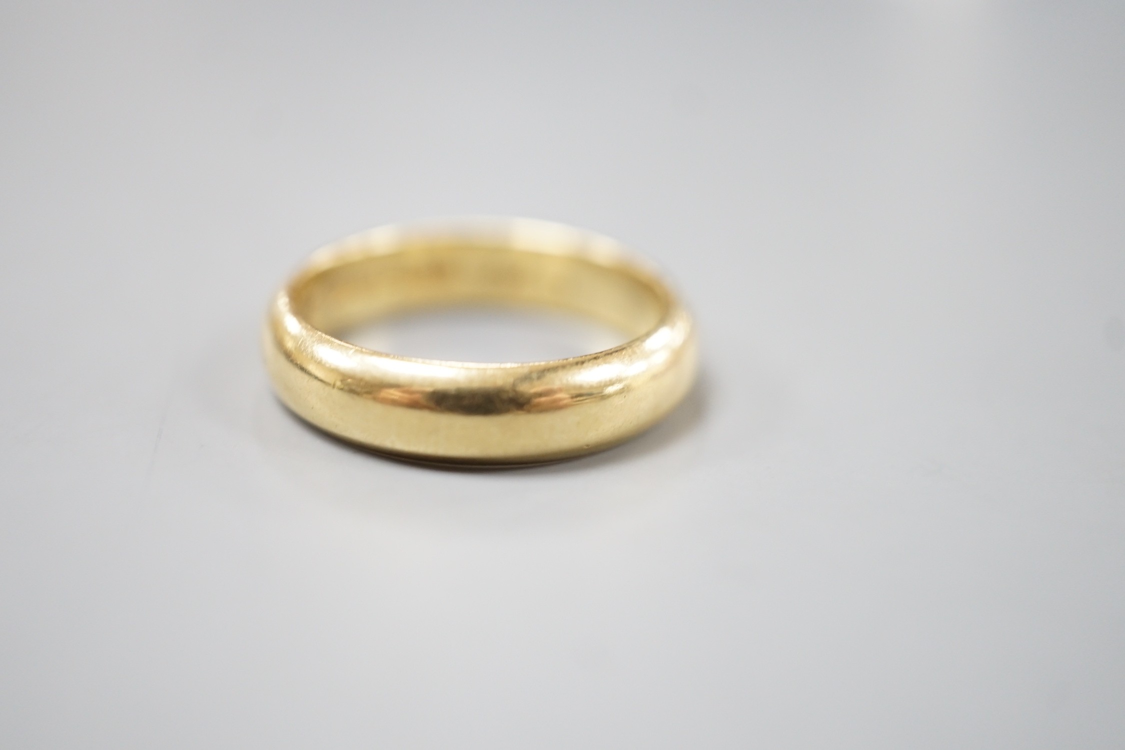 A 1970's 18ct gold wedding band, with engraved inscription, size O/P, 6.7 grams.